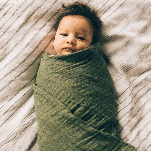 Lightweight cotton muslin swaddle in fern, 120cm x 120cm, perfect for snug swaddling and promoting safer sleep for infants.