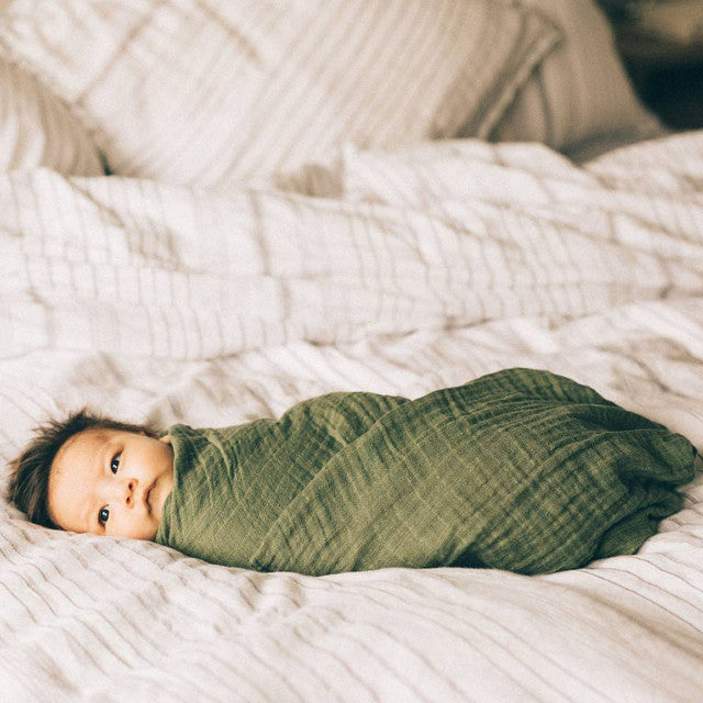 Lightweight 100% cotton muslin swaddle in fern, 120cm x 120cm, perfect for secure swaddling and cozy comfort for infants.