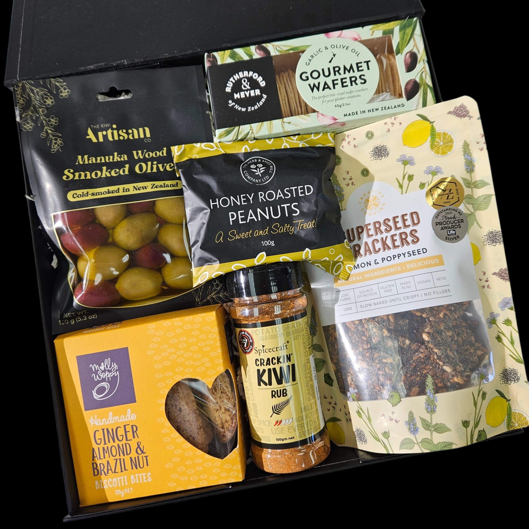 Gourmet gift box with assorted snacks including honey roasted peanuts, gourmet wafers, olives, and biscotti.