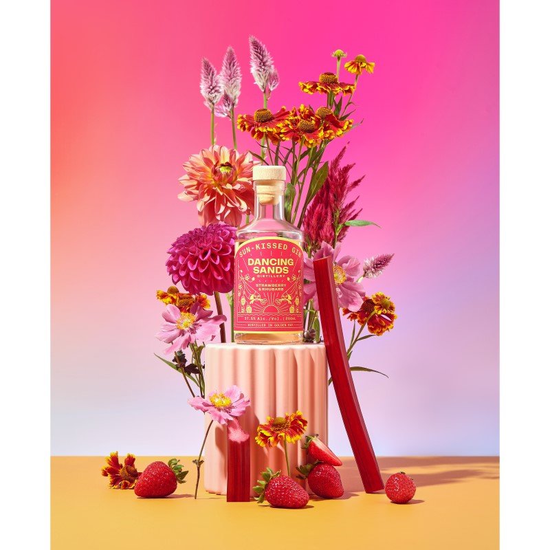 Bottle of Dancing Sands Sun-Kissed Gin (200ml), showcasing pink color and vibrant flavors of strawberries and rhubarb.