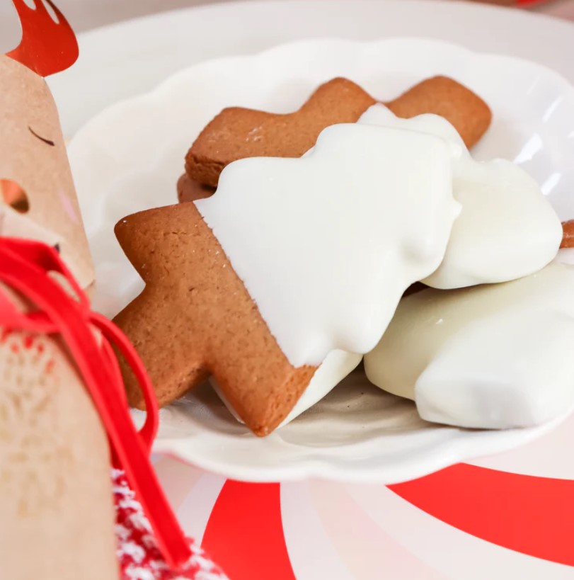 White-chocolate-dipped gingerbread cookies shaped like Christmas trees, perfect for gifts and festive celebrations.