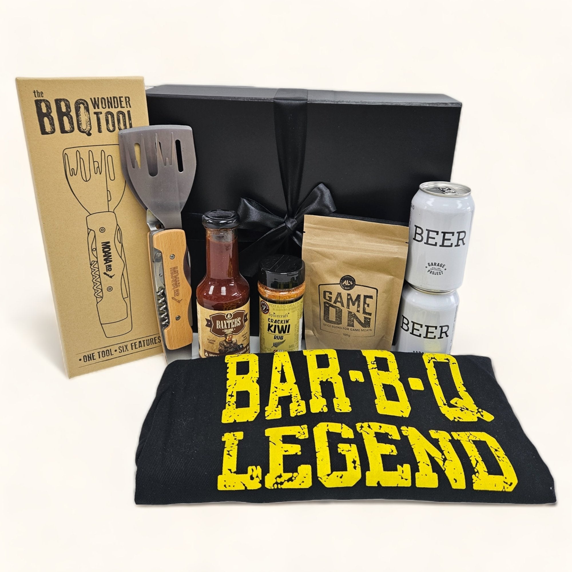 BBQ gift box featuring beer, apron, spice mix, BBQ sauce, and grill tool, perfect for summer gatherings.