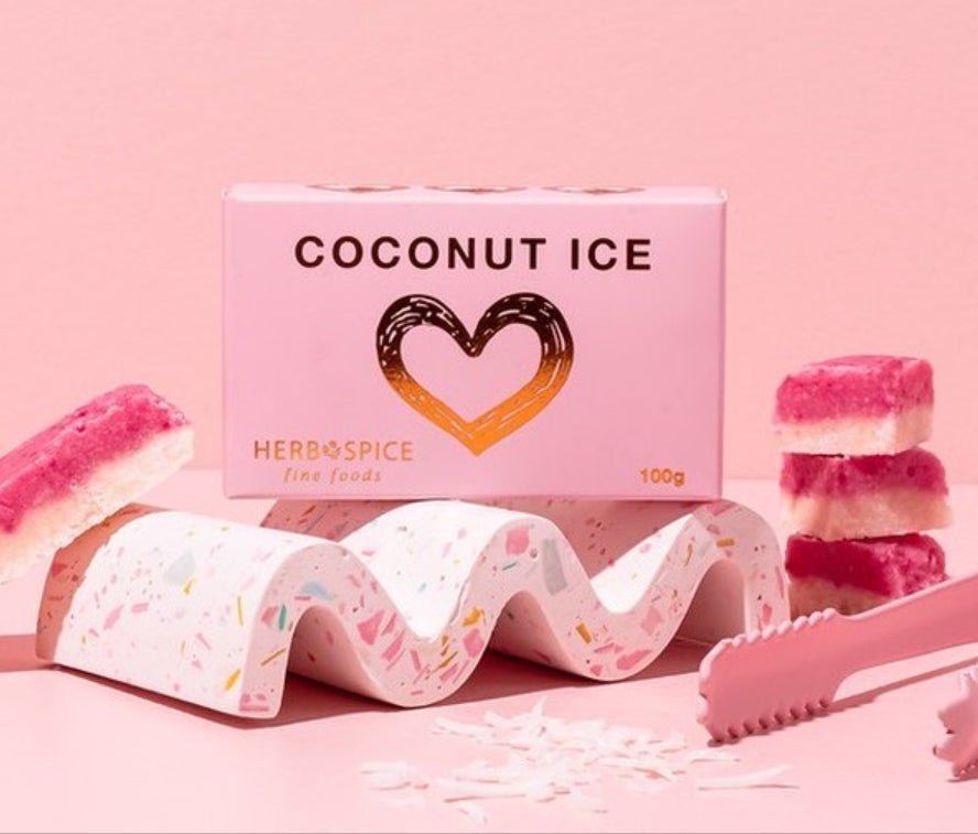 Pink and white Coconut Ice cubes in a 100g package, offering a nostalgic sweet treat with rich coconut flavor.