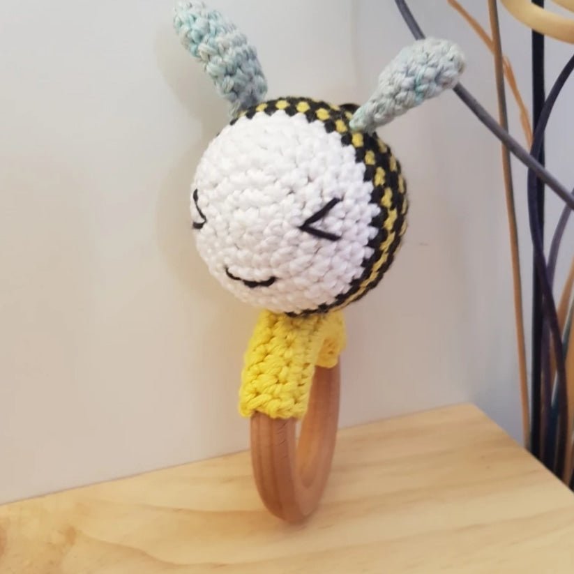 Cute bee rattle/teether with a beechwood ring, made of soft cotton for sensory play and teething relief. Handmade in NZ.