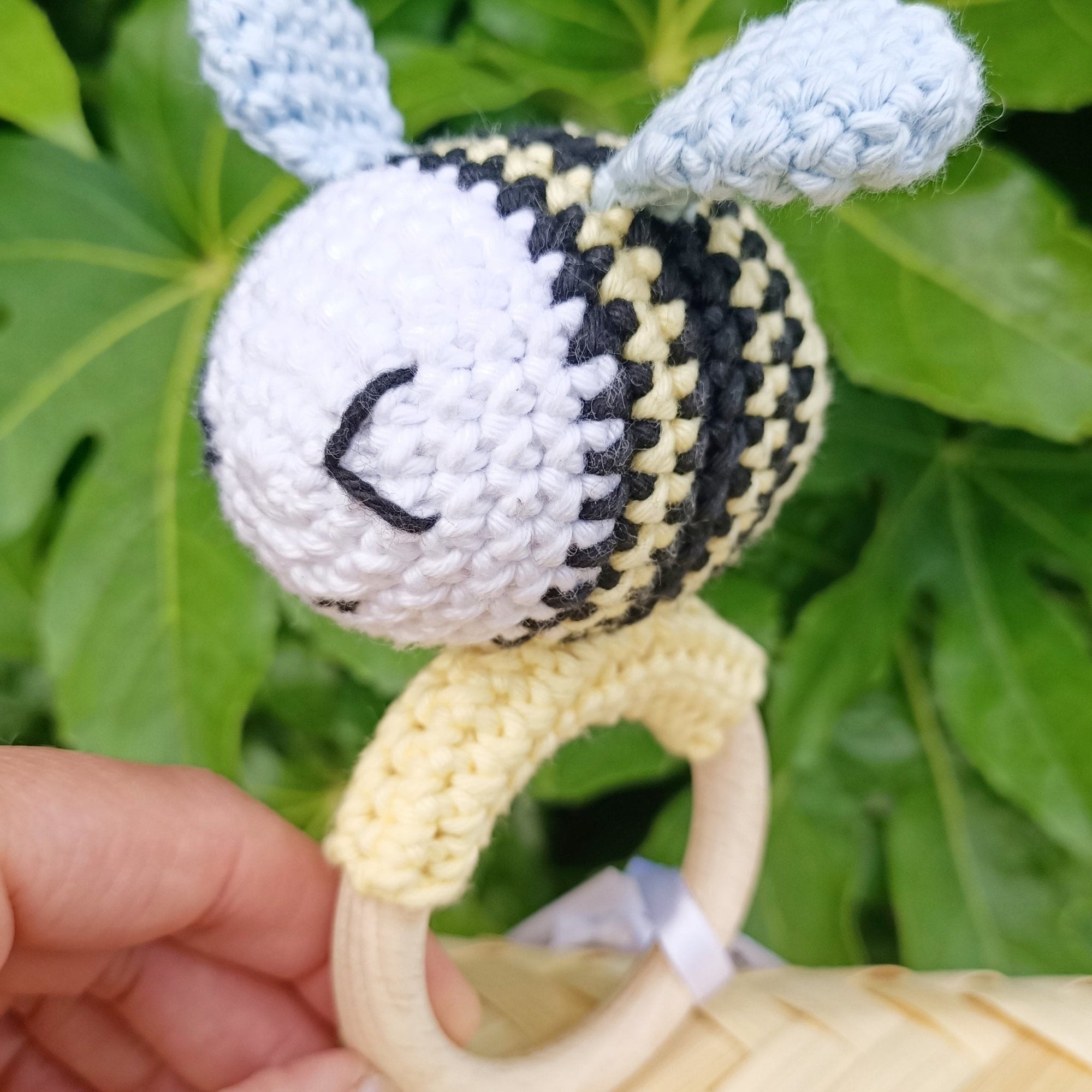 Adorable handmade bee rattle/teether with a natural beechwood ring, perfect for sensory play and teething relief.