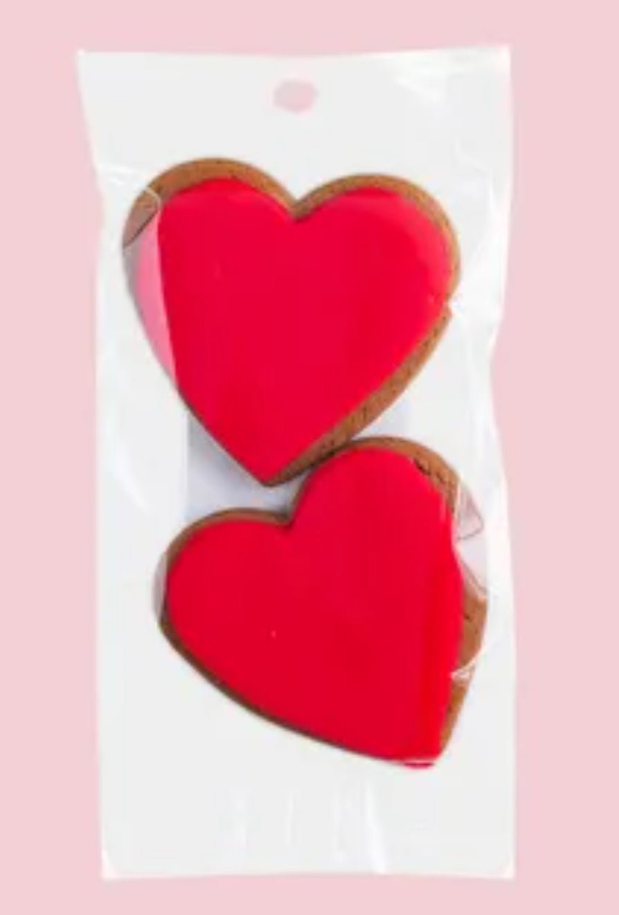 Heart-shaped ginger cookies with red icing in a twin pack, perfect for gifting and special occasions.