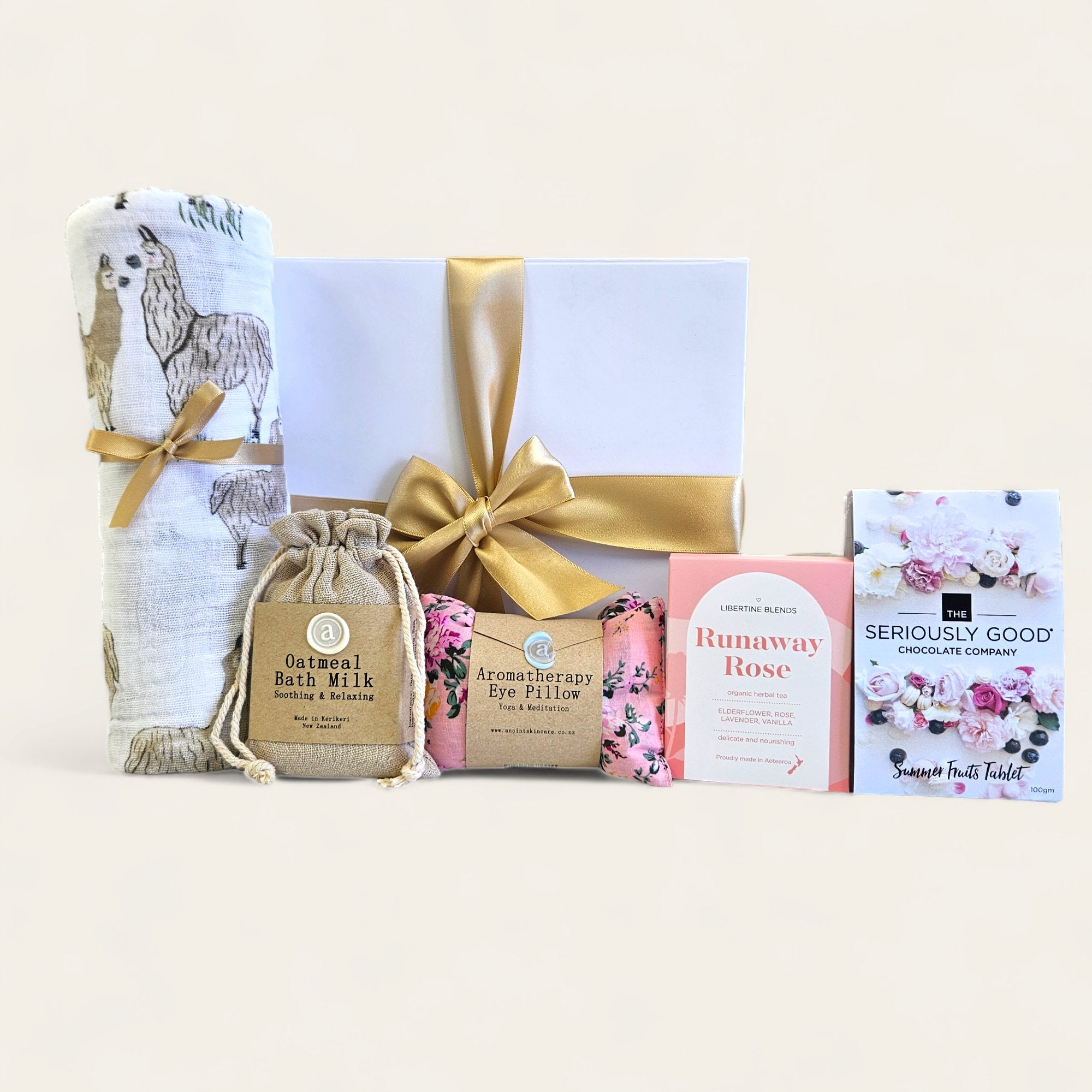 Gift box for new parents featuring soothing baby items and pampering goodies for mum, elegantly packaged with a ribbon.