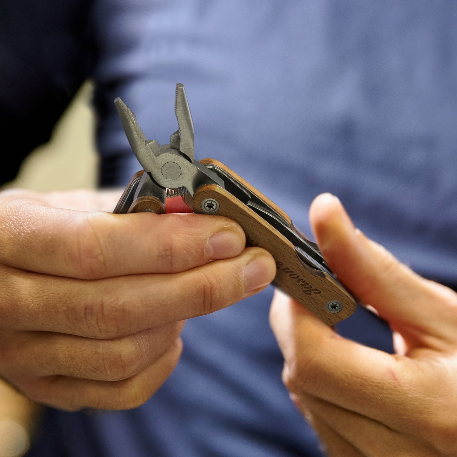 Wooden 9 Function Multi Tool featuring Beech wood handles, spring-loaded pliers, and essential tools for versatile use.