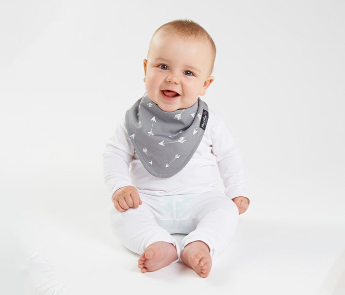 Chic grey arrows reversible baby bib with waterproof layer and adjustable snaps, perfect for ages 4 months to 3 years.