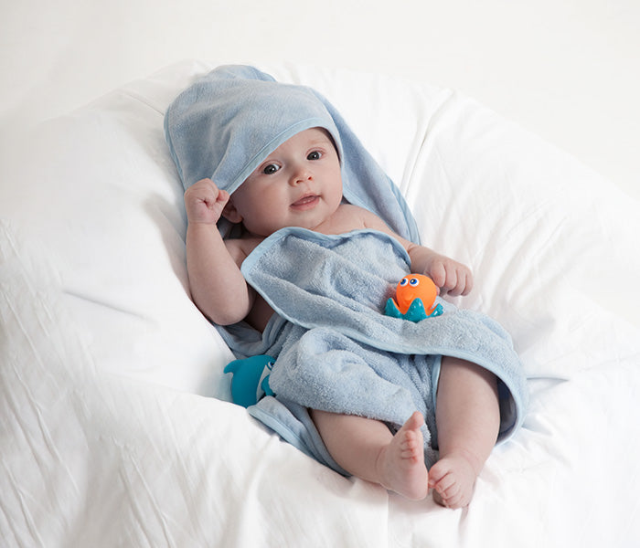 Blue baby hooded towel made from soft 100% cotton, designed for warmth and comfort after bath time.