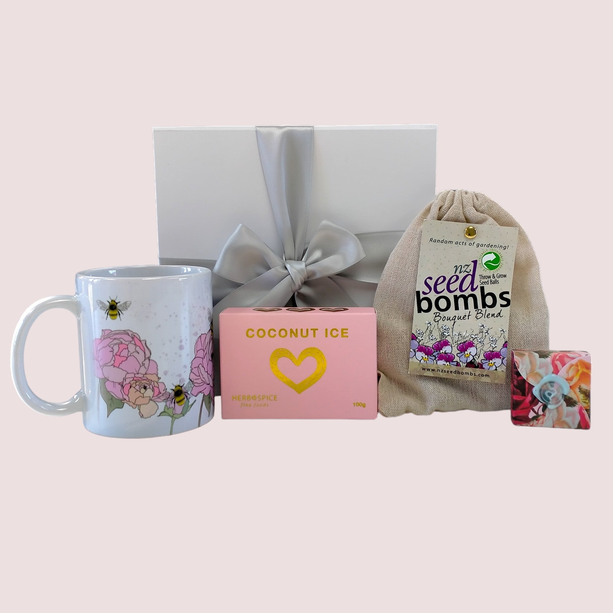 Charming gift box filled with a mug, seed bombs, coconut ice, lip balm, and beautifully designed for any occasion.