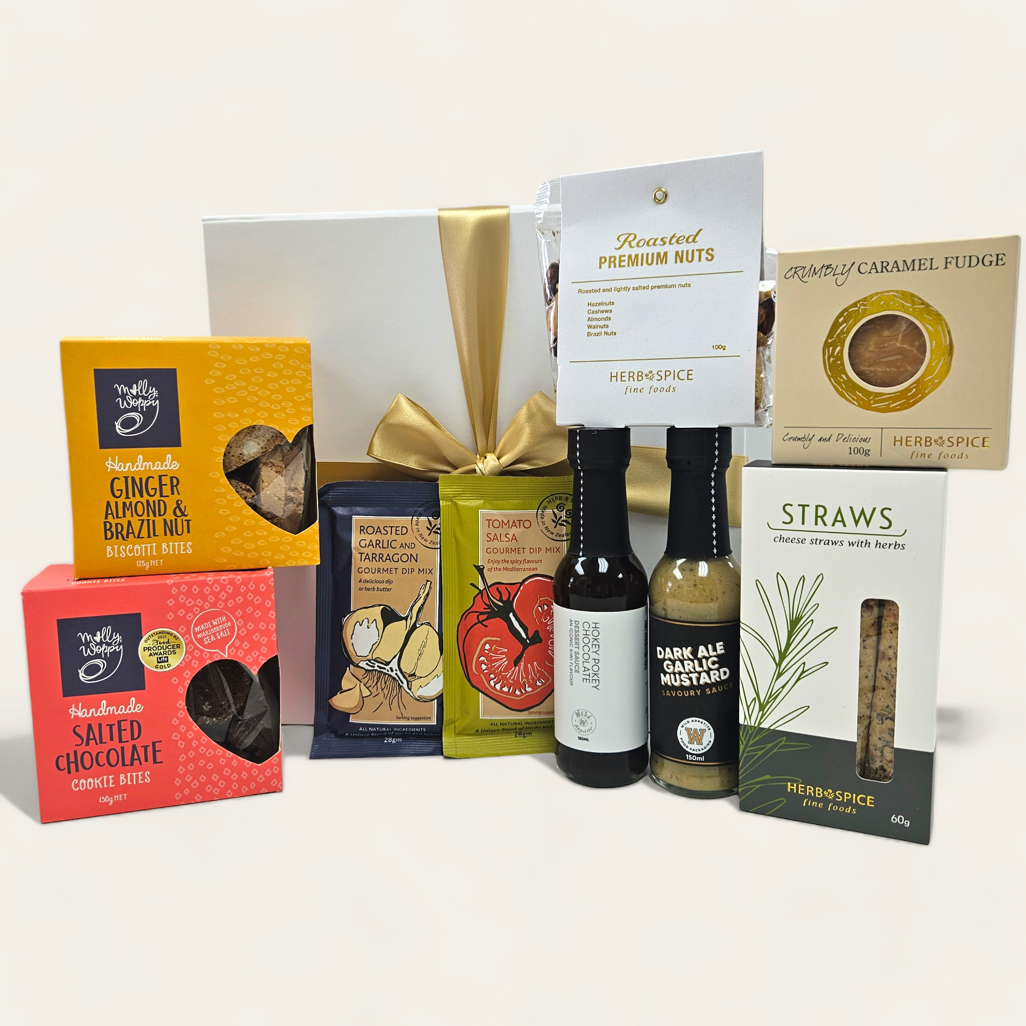 Gourmet gift box filled with sauces, fudge, nuts, and biscuits for food lovers, beautifully presented with a ribbon.