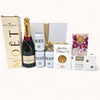 Elegant gift box 'Let's Celebrate' with Champagne, luxury pudding, gummy bears, beers, and chocolate tablet for special occasions.