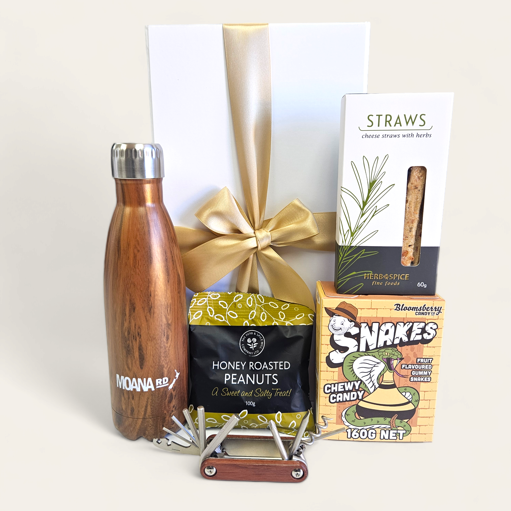 Alt text: "Good On Ya Mate gift box featuring eco-friendly drink bottle, snacks, versatile tool, and chewy candy for thoughtful gifting."