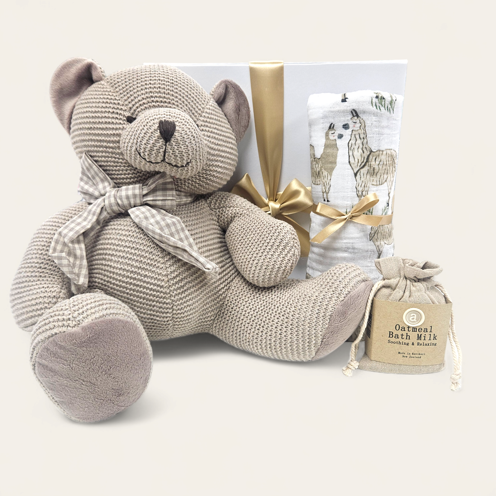 Cuddly Big Ted teddy bear gift set with swaddle, bath milk, and elegant packaging, perfect for newborns.