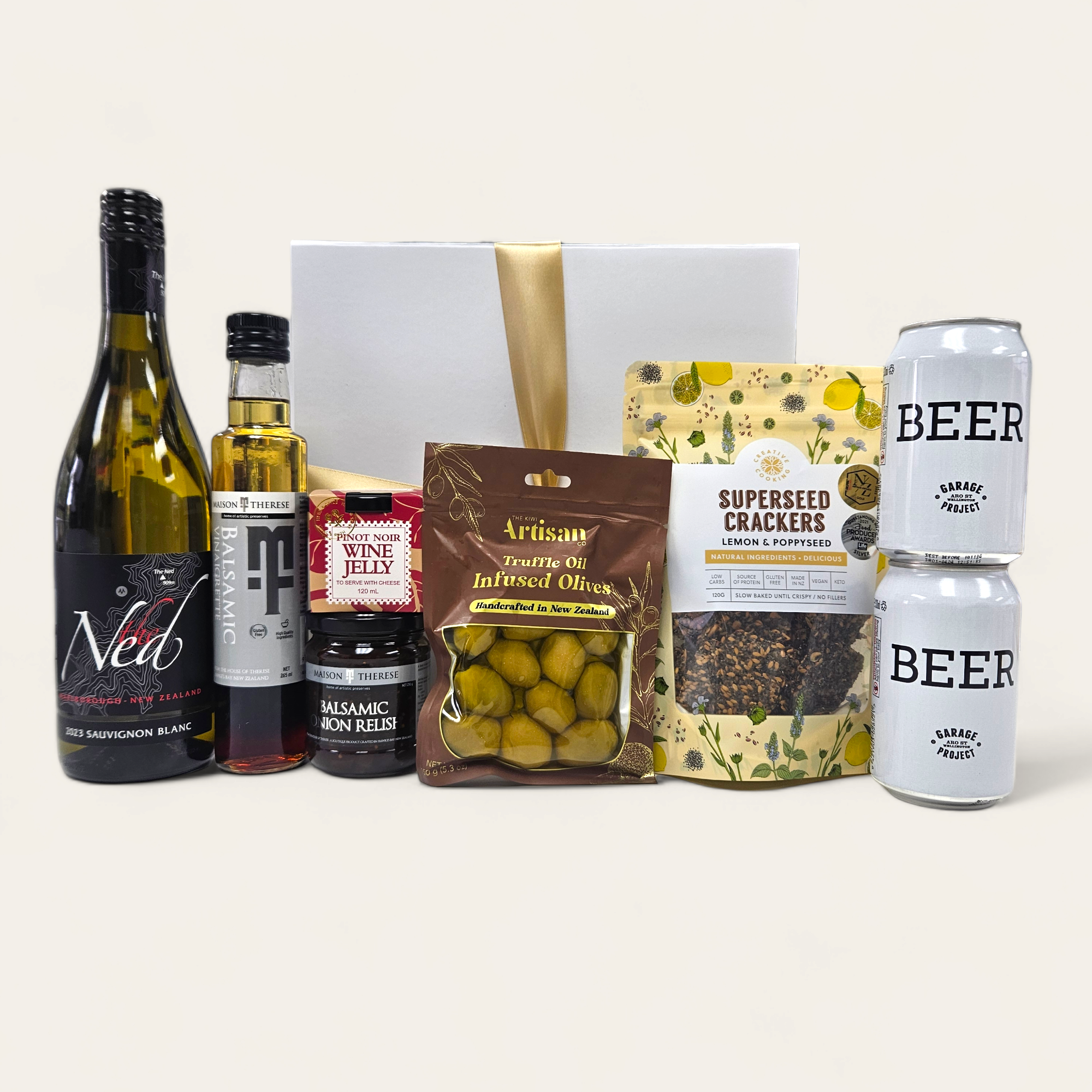 Gift box featuring gourmet treats, including beer, wine jelly, olives, and more, elegantly packaged for any occasion.