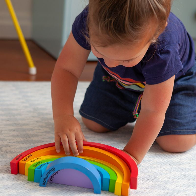 Colorful wooden blocks for learning Te Reo M?ori colors, promoting creativity and cognitive development in children.