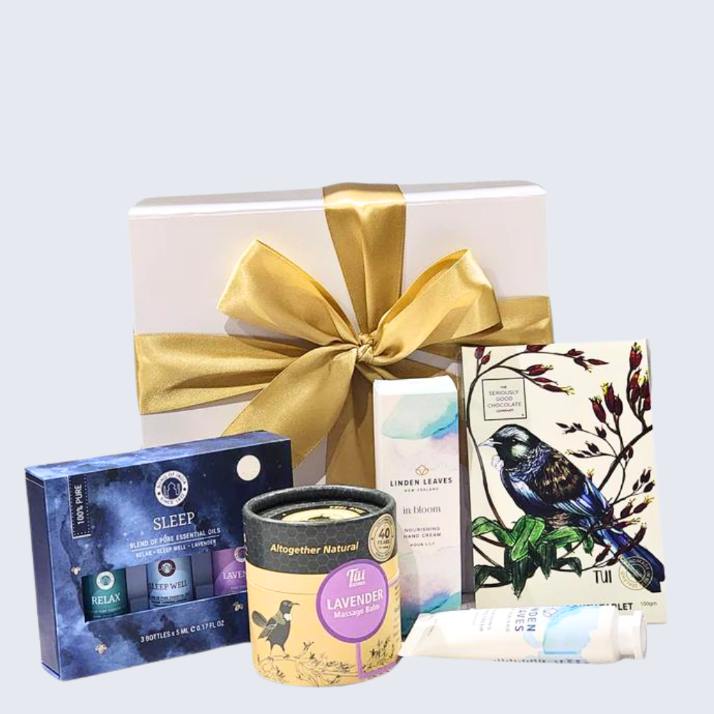 Rest & Unwind gift box featuring calming essential oils, soothing balm, handmade chocolate, and luxurious hand cream.