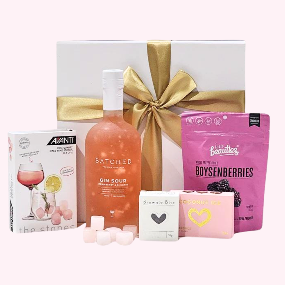 Elegant gift box featuring premium gin, rose quartz chilling stones, and gourmet treats for the perfect refreshing experience.