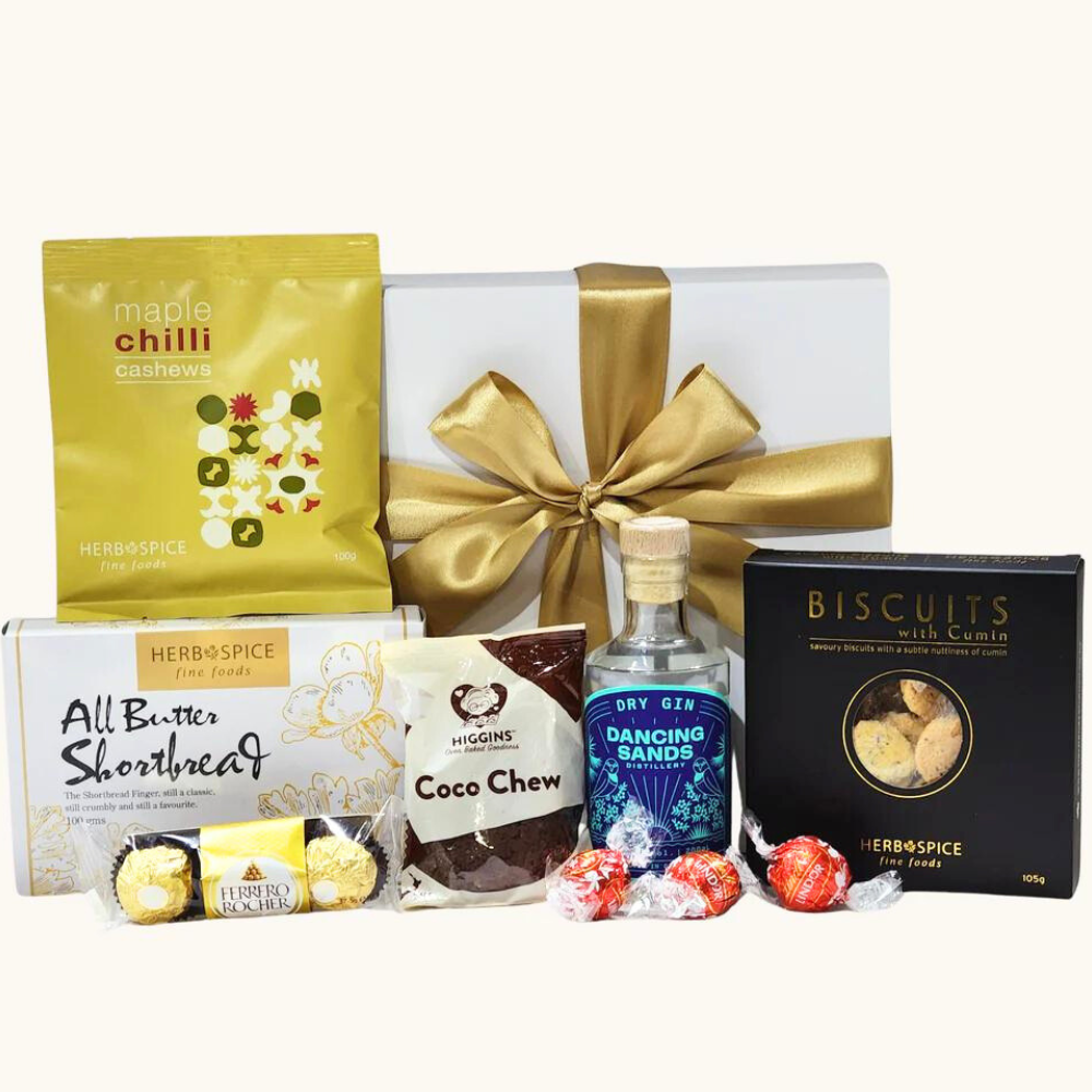 "Gift box featuring Dancing Sands Dry Gin and gourmet treats like chocolate, cashews, and biscuits for special celebrations."