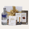 Luxurious gift set featuring Absolut Vodka, gourmet snacks, and rich chocolate, beautifully presented in an elegant box.