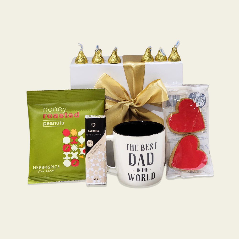 Elegant gift box for dads, featuring a mug, gourmet snacks, and a caramel chocolate bar, perfect for any celebration.