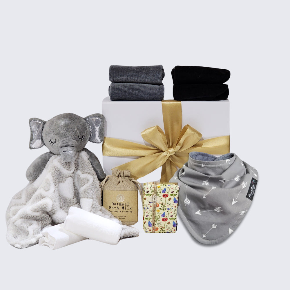 Elephant Snuggles Baby gift set featuring quality care items for newborns, including soap, bath milk, blanket, face cloths, and bib.