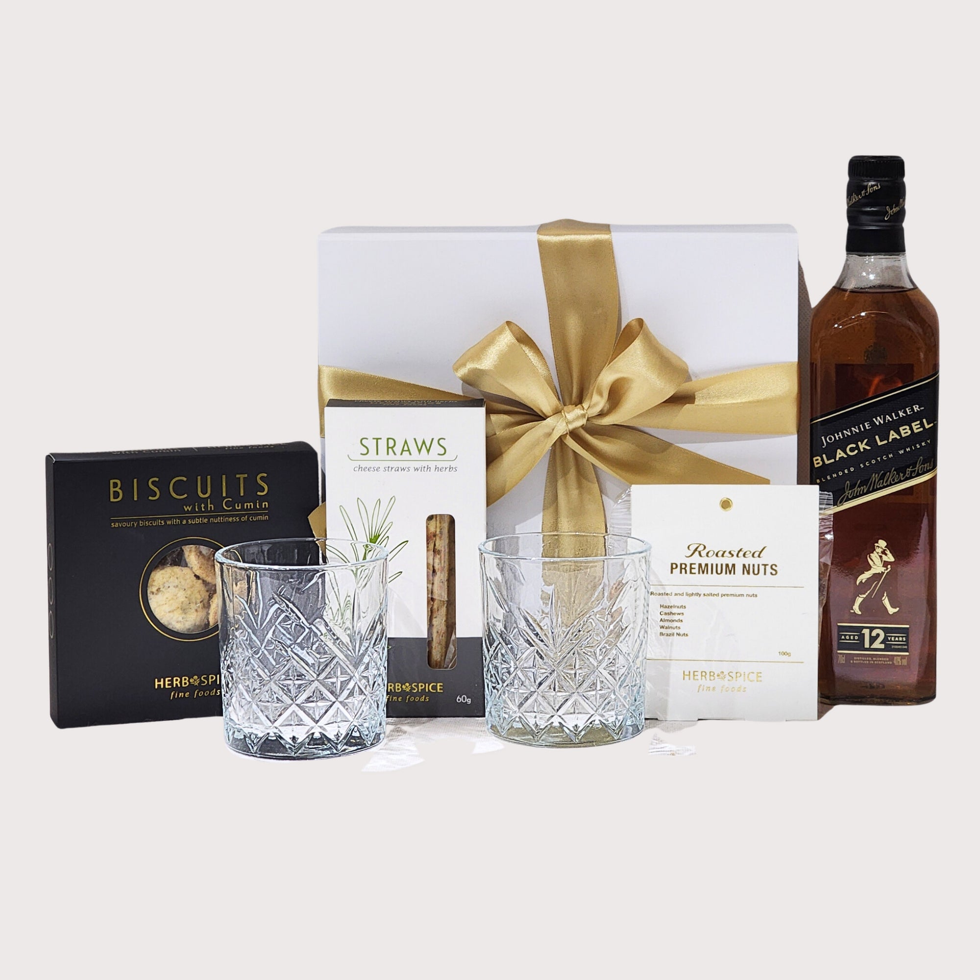 Luxurious Johnnie Walker gift set with premium whisky, Italian glasses, and gourmet snacks in a stylish magnetic box.