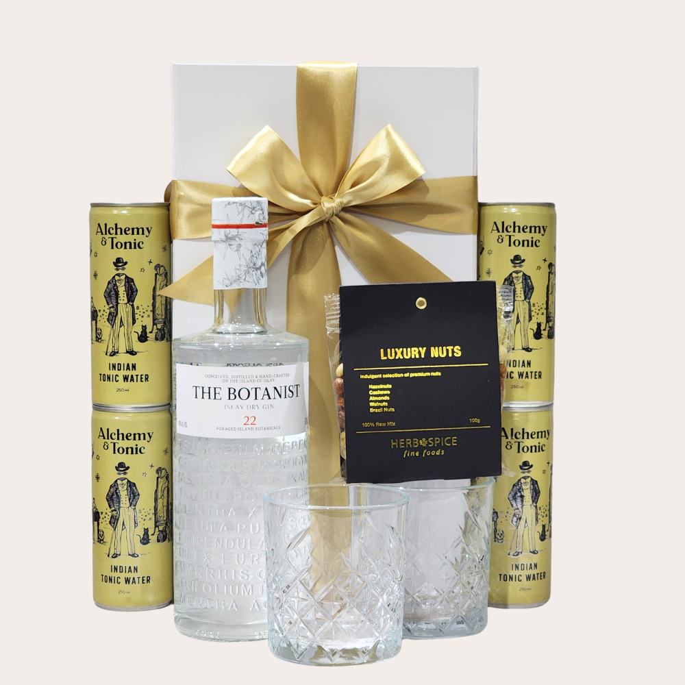 Elegant gift box featuring The Botanist gin, stylish glasses, tonic water, and gourmet snacks for gin lovers.