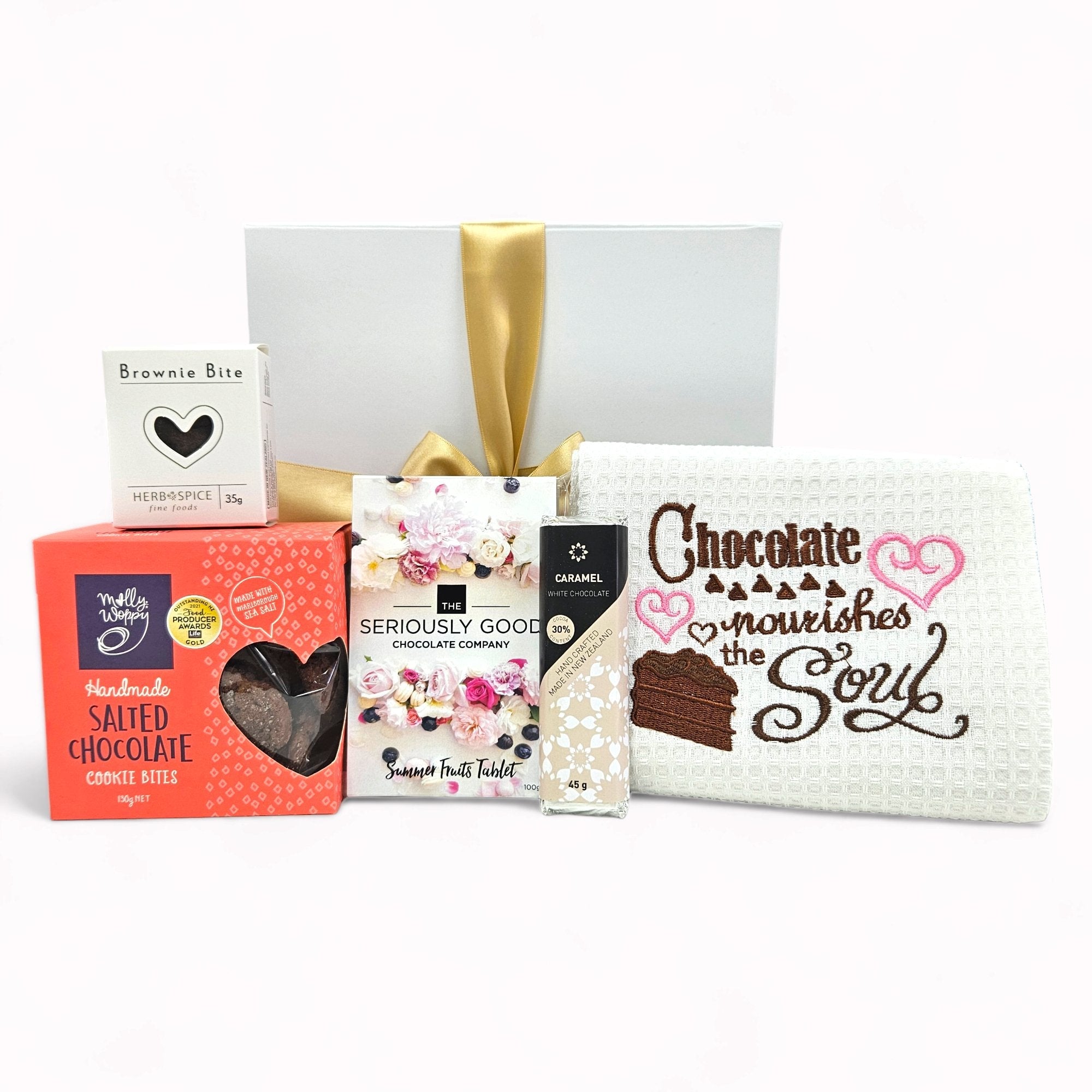 Luxurious 'Chocolate Nourishes The Soul' gift box filled with gourmet chocolates, cookies, and a tea towel for sweet indulgence.