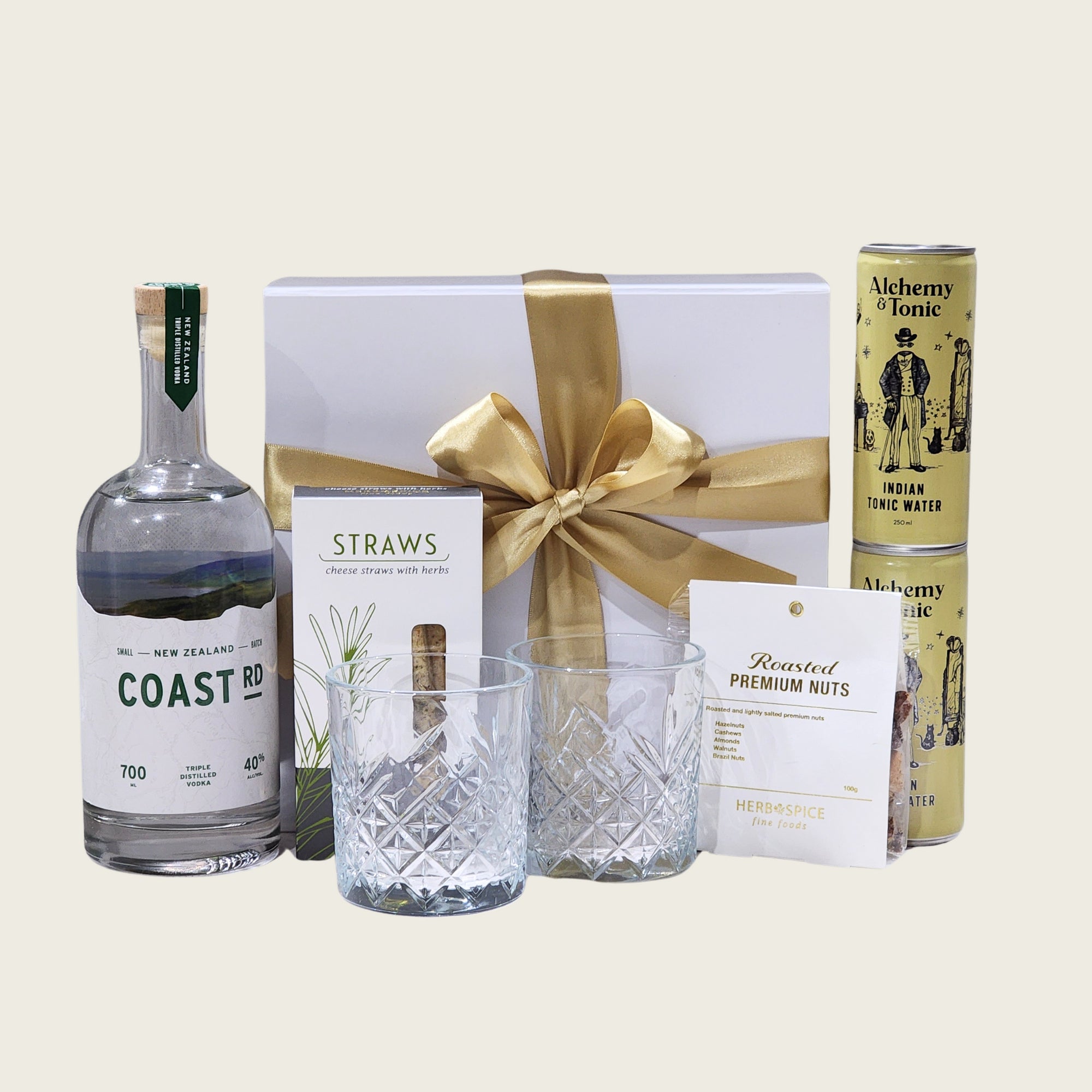 Gift box featuring Coast Road Vodka, tonic water, premium snacks, and elegant glassware, perfect for vodka lovers.