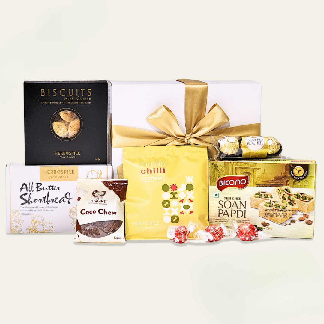 Desi Kiwi Diwali Delight gift box featuring traditional sweets, gourmet chocolates, and savory snacks for festive celebrations.