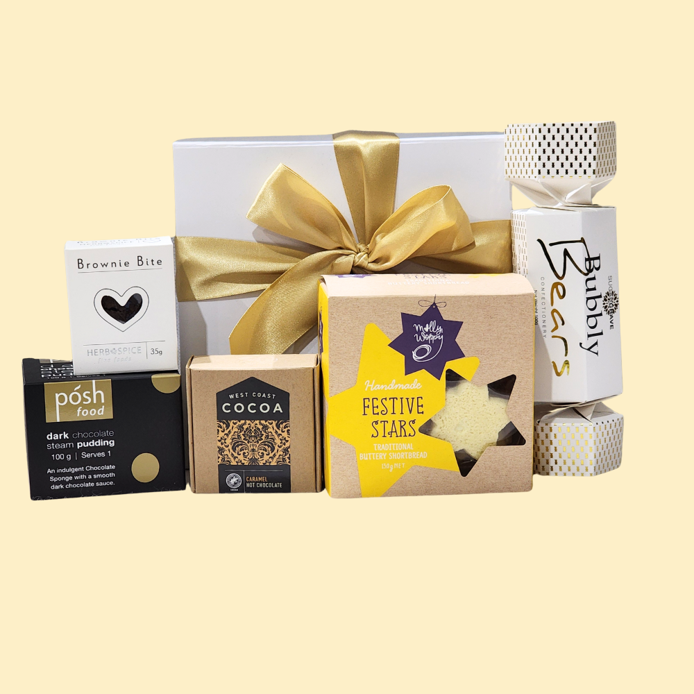 A luxurious holiday gift box filled with gourmet treats, including chocolates, hot chocolate, and festive cookies.
