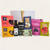 Elegant gift box filled with gourmet treats, including dips, cookies, and snacks, perfect for food lovers.