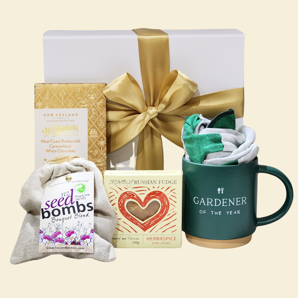 Gift box for gardening enthusiasts, featuring a mug, seed bombs, gloves, and treats in a ribboned magnetic closure box.