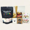 Gourmet Hot Choc gift box with NZ-made treats: marshmallows, chocolate tablet, brownie bites, and more, elegantly presented.