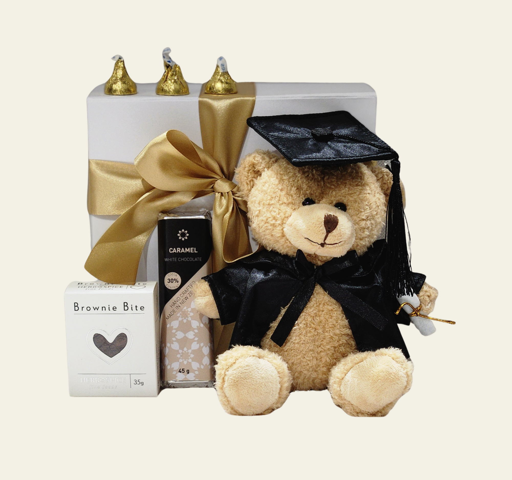 "Gift box with treats and a teddy bear, celebrating graduation success with elegance and charm."