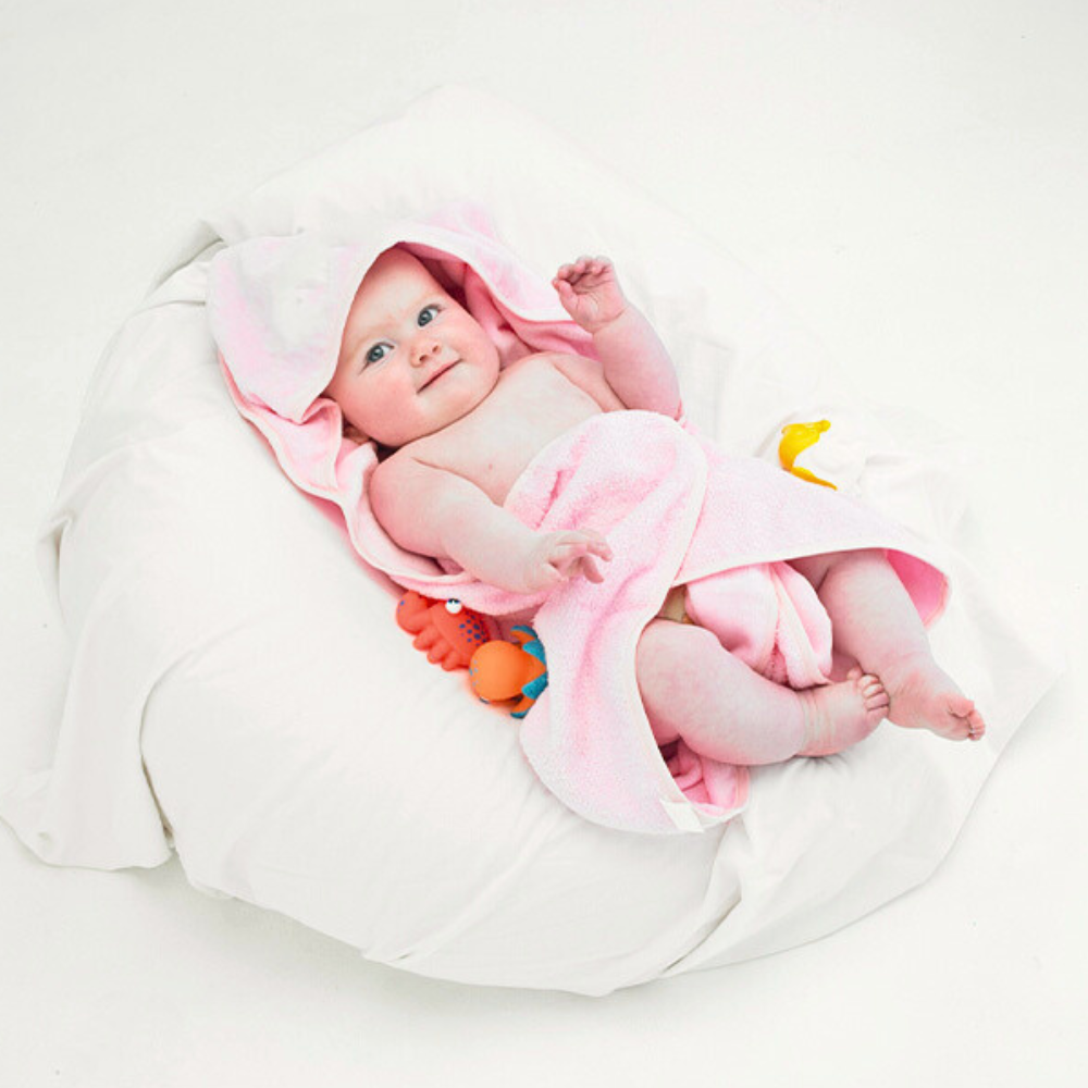 Soft pink baby hooded towel made from 100% cotton, perfect for keeping your little one warm and dry after bath time.