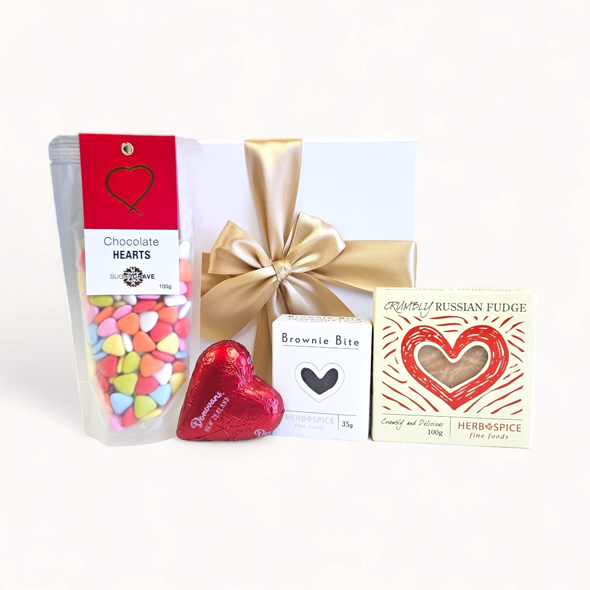 Love Bite gift box featuring fudge, chocolate hearts, brownie bites, and elegant packaging, perfect for expressing affection.