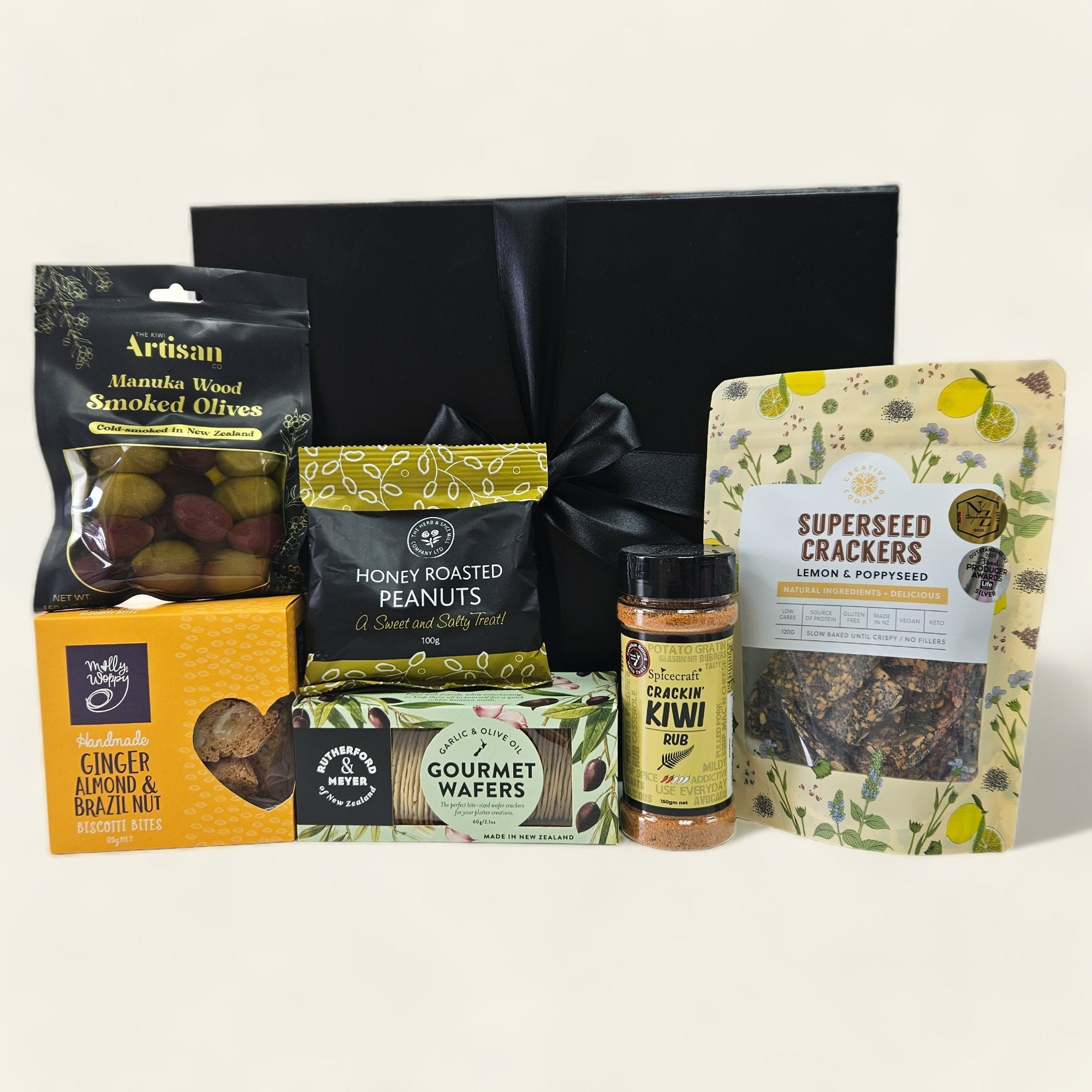 Oh So Savoury gift box featuring gourmet snacks like honey roasted peanuts, gourmet wafers, and smoked olives.