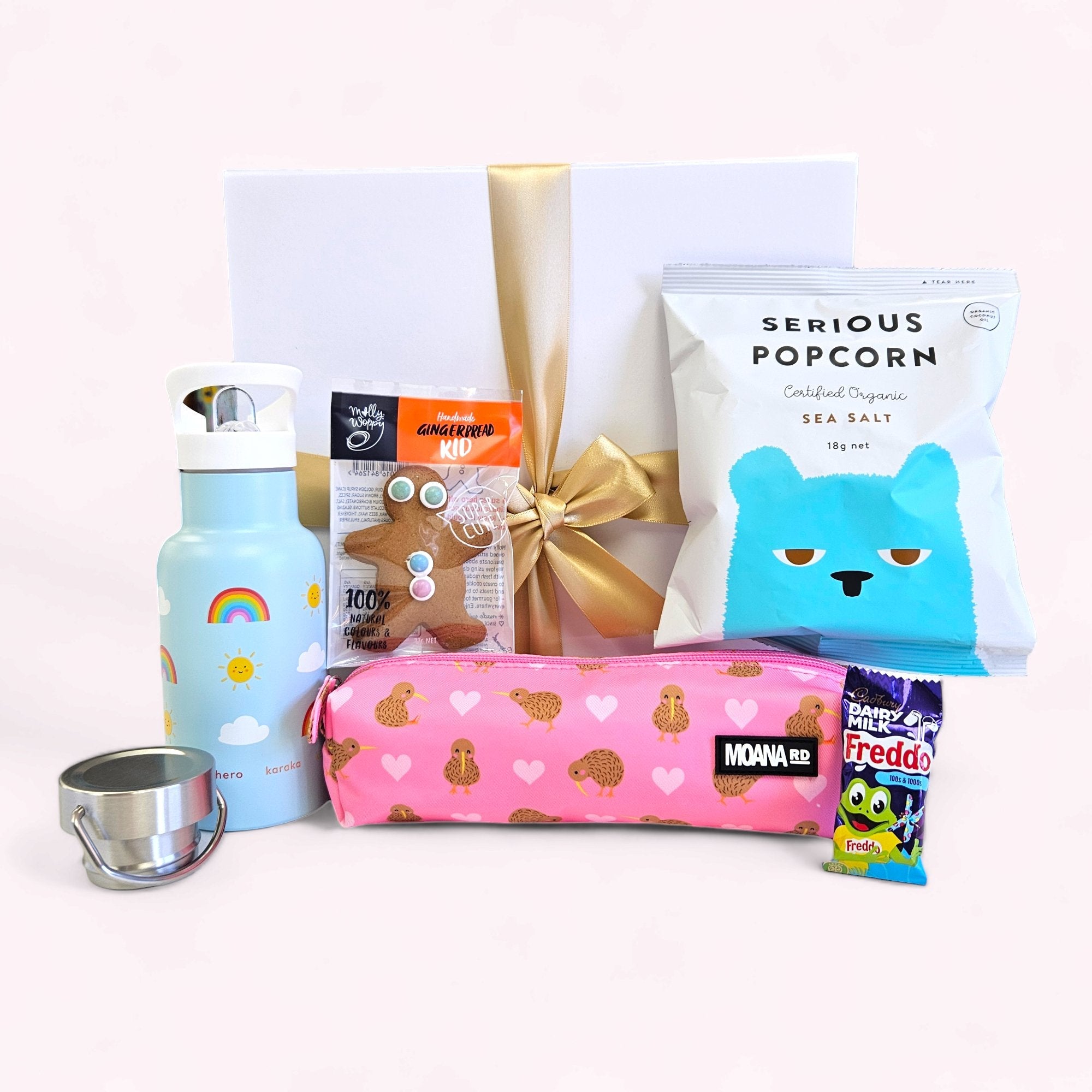 Charming pink gift box for kids filled with treats like popcorn, biscuits, and a pencil case, perfect for any occasion.