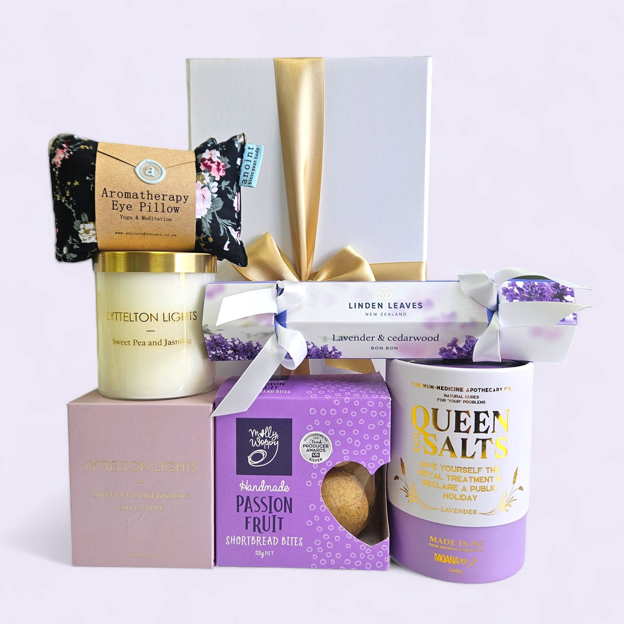 Luxurious Pamper Queen gift box with soothing lavender products, aromatic candle, eye pillow, and passionfruit shortbread.