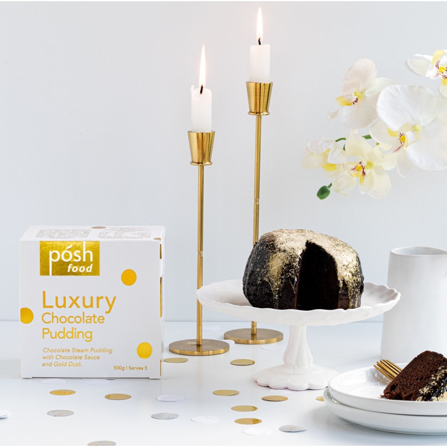 Posh Luxury Chocolate Steam Pudding embellished with edible gold dust, featuring a soft center and rich dark chocolate sauce.