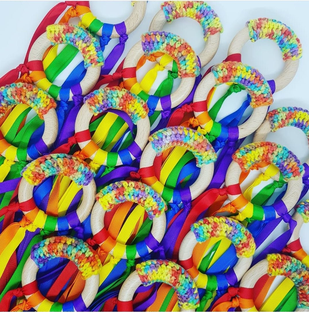 Vibrant Rainbow Ribbon Teether with soft ribbons for sensory play, handcrafted in NZ, safe and perfect for babies to chew.