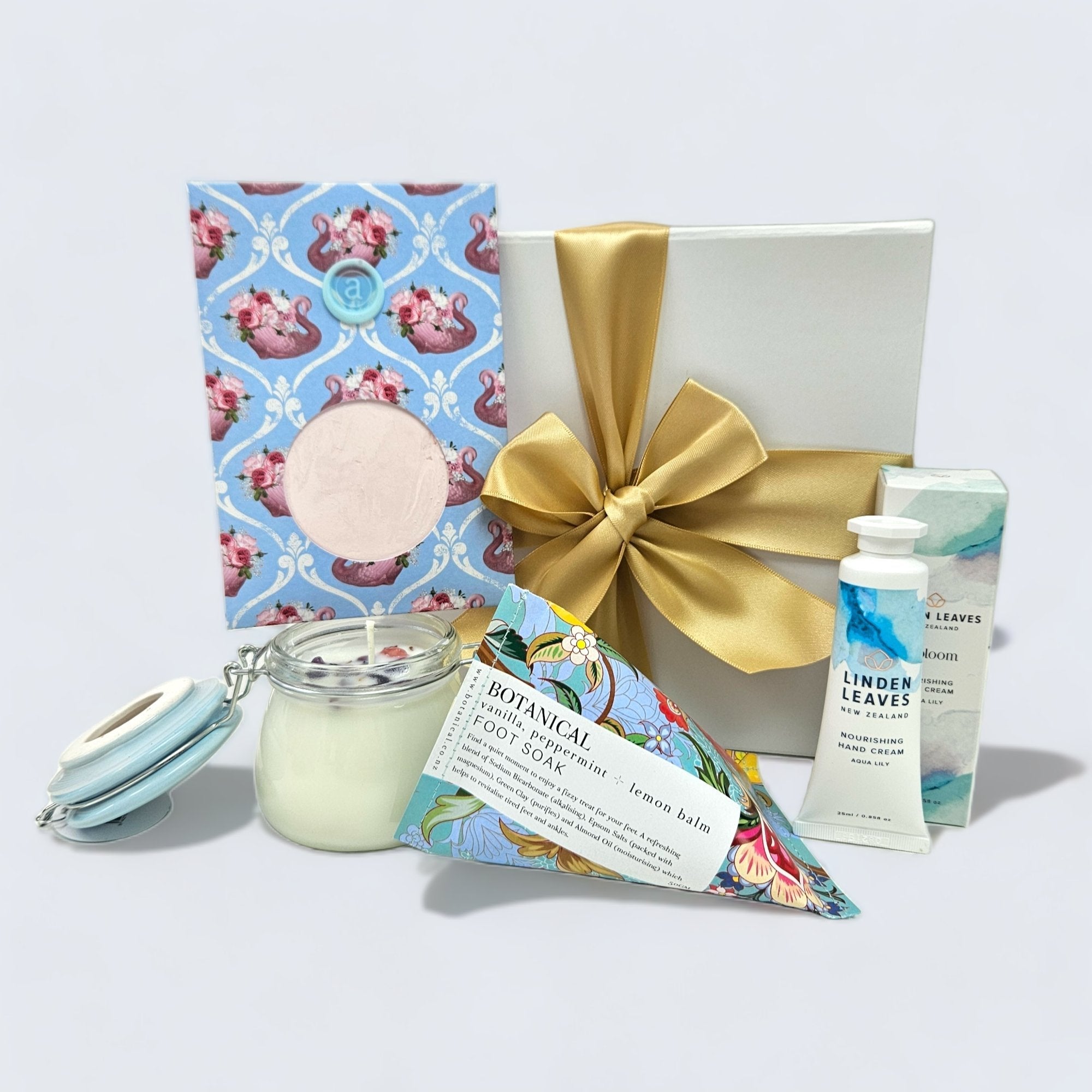 Retreat (Blue) gift box featuring aromatherapy candle, hand cream, facial mask, foot soak, and elegant packaging for self-care.
