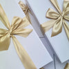 Elegant gift box featuring Ned Sauvignon Blanc and gourmet treats like honey-roasted peanuts and balsamic onion relish.