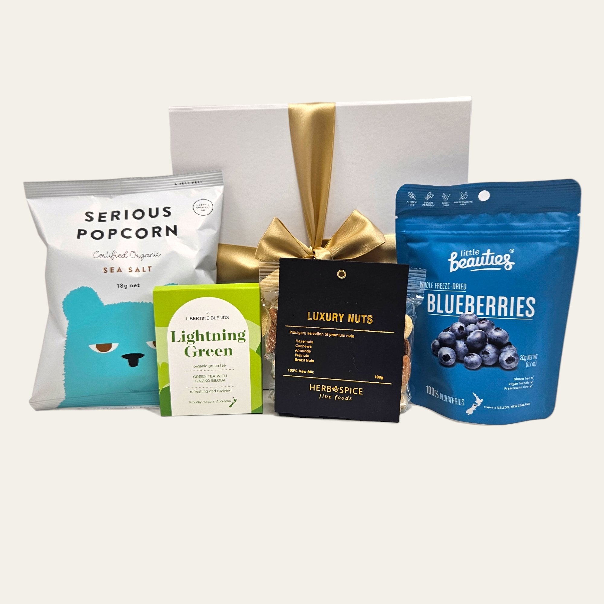 Elegant gift box filled with vegan treats like popcorn, tea, blueberries, and luxury nuts, perfect for health-conscious gifting.